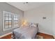 Bright bedroom with ample natural light from large windows, featuring a comfortable bed and hardwood flooring at 6404 Mayra Shores Ln, Apollo Beach, FL 33572