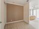 View of bedroom with carpeted floor, and view to Primary bedroom with sliding glass door at 6404 Mayra Shores Ln, Apollo Beach, FL 33572