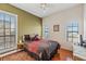 Comfortable bedroom featuring hardwood floors, a ceiling fan, and large windows offering natural light at 6404 Mayra Shores Ln, Apollo Beach, FL 33572