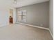 Spacious bedroom with a window, carpet flooring, and light-grey wall at 6404 Mayra Shores Ln, Apollo Beach, FL 33572