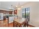 Inviting dining area adjacent to the kitchen, featuring a large window for natural light and modern lighting at 6404 Mayra Shores Ln, Apollo Beach, FL 33572
