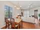 Bright dining area with a dining table set, chandelier lighting, and a view into the living room at 6404 Mayra Shores Ln, Apollo Beach, FL 33572