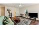 Well-lit living room with hardwood floors, a ceiling fan, neutral paint, and comfortable seating at 6404 Mayra Shores Ln, Apollo Beach, FL 33572