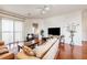 Cozy living room with hardwood floors, modern decor, and a view of the adjacent dining area and kitchen at 6404 Mayra Shores Ln, Apollo Beach, FL 33572