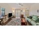 Cozy living room with hardwood floors, a ceiling fan, neutral paint, and comfortable seating at 6404 Mayra Shores Ln, Apollo Beach, FL 33572
