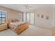Spacious main bedroom with large bed, ensuite bathroom, and natural light from sliding doors and windows at 6404 Mayra Shores Ln, Apollo Beach, FL 33572