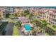Aerial view of pool area surrounded by palm trees, with lounge seating and small building at 6404 Mayra Shores Ln, Apollo Beach, FL 33572