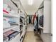 Walk-in closet featuring custom shelving and plenty of storage space for clothing and accessories at 6404 Mayra Shores Ln, Apollo Beach, FL 33572