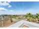 Scenic water view from above, overlooking a road lined with palm trees and well maintained houses at 6404 Mayra Shores Ln, Apollo Beach, FL 33572
