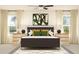 Serene bedroom featuring a queen bed, contemporary art, and bright windows at 6483 Propel Run, New Port Richey, FL 34655