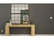 Stylish hallway decor featuring a wooden console table, decorative items, and a grid-pattern mirror at 6483 Propel Run, New Port Richey, FL 34655