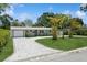 Charming single-story home with well-maintained landscaping and a patterned driveway and walkway at 6519 15Th N St, St Petersburg, FL 33702