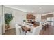 Open dining area connected to kitchen with natural light, modern finishes, and wood flooring at 7783 Wheat Stone Dr, Zephyrhills, FL 33540