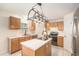 Traditional kitchen with wood cabinets, stainless steel appliances, and a center island at 8388 Maltby Rd, Spring Hill, FL 34606