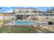 Lovely outdoor pool area with seating, perfect for entertaining or relaxing by the water at 8388 Maltby Rd, Spring Hill, FL 34606