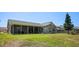Expansive backyard featuring a well-kept lawn and a screened-in patio area, offering ample space for relaxation at 8712 Ashbury Dr, Hudson, FL 34667