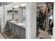Dual-sink bathroom vanity with modern fixtures and ample storage, plus a walk-in closet at 8712 Ashbury Dr, Hudson, FL 34667
