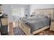Bedroom with a large bed, wood floors, and ample natural light from the sliding glass door at 8712 Ashbury Dr, Hudson, FL 34667
