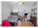 Bedroom with a cozy setup, featuring a bed, desk, and a bright window with curtains at 8712 Ashbury Dr, Hudson, FL 34667