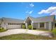 Charming single-story home with a spacious driveway and a two-car garage, surrounded by neatly trimmed bushes at 8712 Ashbury Dr, Hudson, FL 34667