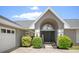 Inviting home exterior highlighting a welcoming front entrance with double doors, decorative plants and sidelights at 8712 Ashbury Dr, Hudson, FL 34667