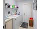 A functional laundry room with washer, dryer and some storage at 8712 Ashbury Dr, Hudson, FL 34667