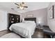 Comfortable bedroom features a king bed, ceiling fan, and dark wood floors at 9412 Azalea Ridge Cir, Tampa, FL 33647