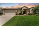 Charming single-story home featuring lush green lawn, well-manicured landscaping, and a two-car garage at 9412 Azalea Ridge Cir, Tampa, FL 33647