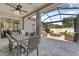 Screened-in patio with a ceiling fan, outdoor seating, and a view of the backyard at 9412 Azalea Ridge Cir, Tampa, FL 33647