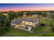Aerial view of house with screened in lanai, and lots of natural light, nestled among the trees at 10117 Breezy Pines Ct, Weeki Wachee, FL 34613