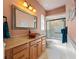 Bathroom features a glass bowl sink, wooden cabinets, and a shower with glass doors at 10117 Breezy Pines Ct, Weeki Wachee, FL 34613