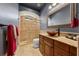 Modern bathroom with a tile shower, decorative glass block window, vessel sink, and neutral color scheme at 10117 Breezy Pines Ct, Weeki Wachee, FL 34613