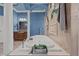 A large soaking tub highlights this bathroom, with blue walls and elegant decor at 10117 Breezy Pines Ct, Weeki Wachee, FL 34613
