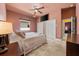 Cozy bedroom featuring a ceiling fan, a TV, two closets, and access to another room at 10117 Breezy Pines Ct, Weeki Wachee, FL 34613