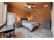 Bedroom featuring warm lighting, desk near window, neutral color scheme, tile floors and a ceiling fan at 10117 Breezy Pines Ct, Weeki Wachee, FL 34613