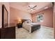 Inviting bedroom with neutral decor, a ceiling fan, tile floors, and a view to the outside at 10117 Breezy Pines Ct, Weeki Wachee, FL 34613