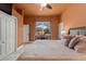 Bright bedroom features tile floors, closet and a large window to the backyard view and a ceiling fan at 10117 Breezy Pines Ct, Weeki Wachee, FL 34613