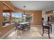 Dining area with a view of the pool and lanai, complemented by a modern light fixture at 10117 Breezy Pines Ct, Weeki Wachee, FL 34613