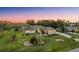 Beautiful home exterior with manicured landscaping, lush lawn, and palm trees, offering curb appeal at 10117 Breezy Pines Ct, Weeki Wachee, FL 34613