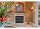 Close-up showcasing the fireplace with a decorative mantle, complemented by a floral arrangement and sconce lighting at 10117 Breezy Pines Ct, Weeki Wachee, FL 34613