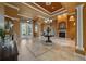 Spacious foyer featuring tile floors, a fireplace, and double doors, offering a glimpse into the home's elegant design at 10117 Breezy Pines Ct, Weeki Wachee, FL 34613