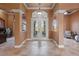 Welcoming foyer with decorative tile flooring, elegant double doors, and arched entryways, creating a grand entrance at 10117 Breezy Pines Ct, Weeki Wachee, FL 34613
