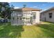 Backyard view showcasing a charming greenhouse, ideal for gardening enthusiasts and plant lovers at 10117 Breezy Pines Ct, Weeki Wachee, FL 34613