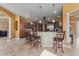 Open kitchen featuring an island with barstool seating, custom cabinets and stainless appliances at 10117 Breezy Pines Ct, Weeki Wachee, FL 34613