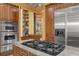 Gourmet kitchen with stainless steel appliances, gas cooktop, and custom cabinetry with built-in pantry at 10117 Breezy Pines Ct, Weeki Wachee, FL 34613