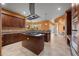 Open concept kitchen with an island cooktop, custom cabinets, and a view of the outdoor lanai at 10117 Breezy Pines Ct, Weeki Wachee, FL 34613