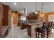 Gourmet kitchen with stainless steel appliances, island with cooktop, and bar stool seating at 10117 Breezy Pines Ct, Weeki Wachee, FL 34613