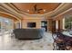 Living area with coffered ceilings, entertainment system, access to the pool, and a dining area at 10117 Breezy Pines Ct, Weeki Wachee, FL 34613
