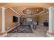 Open living room with tile flooring, entertainment system, and coffered ceilings at 10117 Breezy Pines Ct, Weeki Wachee, FL 34613