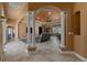 Spacious living room with tile flooring, columns, coffered ceilings, and plenty of natural light at 10117 Breezy Pines Ct, Weeki Wachee, FL 34613